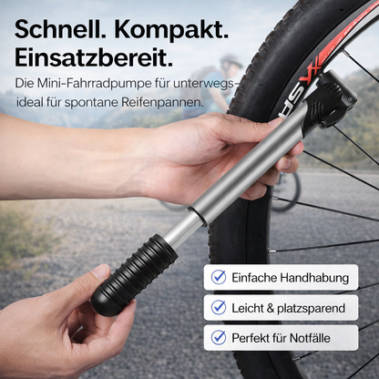 Mini-Fahrradpumpe im Einsatz am Fahrradreifen, von Hand bedient während des Aufpumpens.